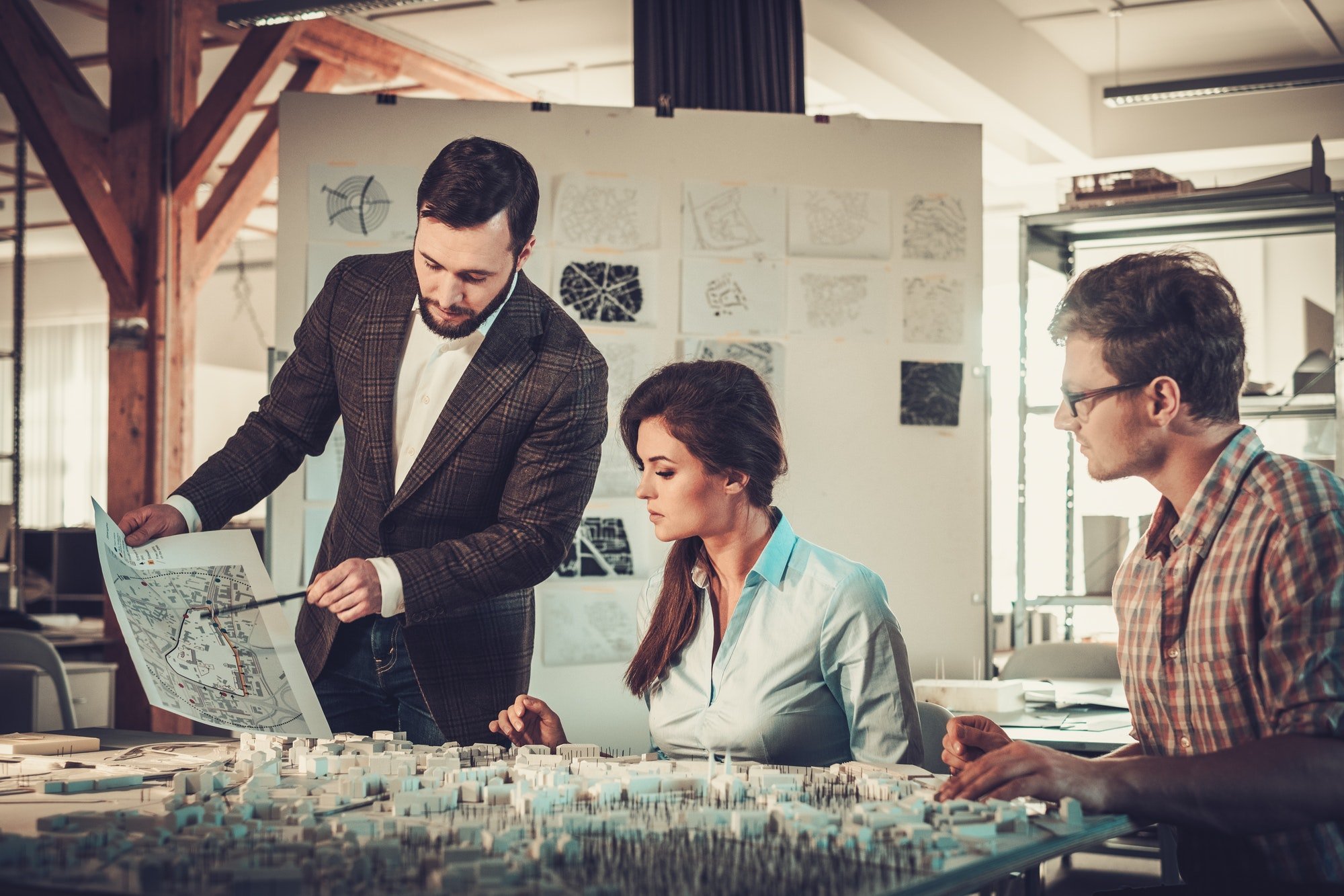 Confident team of engineers working together in a architect stud