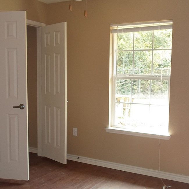 Pine-Ridge-Manor-Crockett-TX-bedroom-with-faux-hardwood-flooring